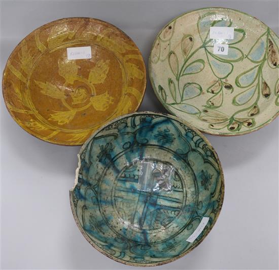 A Persian fritware bowl, 18th/19th century and two slipware bowls